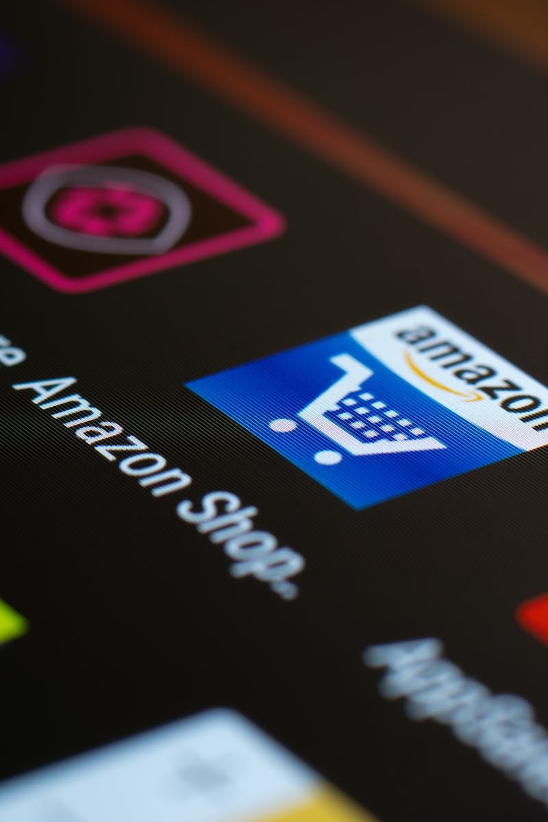 Close-up of the Amazon shopping app icon on a smartphone screen. Ideal for online shopping and technology themes.